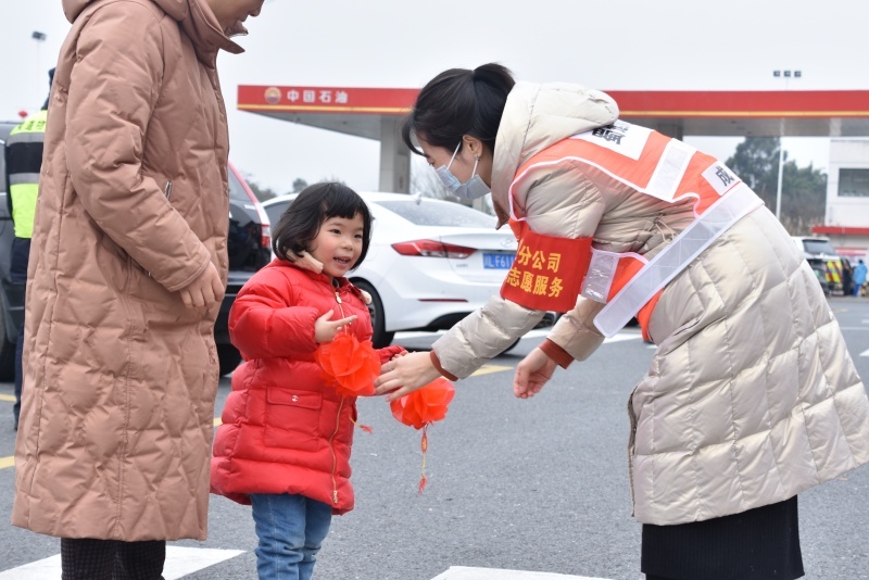 蜀道集團(tuán)成渝公司成仁高速永興服務(wù)區(qū)志愿服務(wù)者向司乘朋友贈(zèng)送禮品掛件。蜀道集團(tuán)供圖